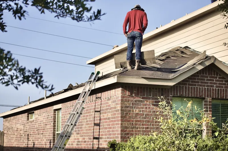 Professional roofer working on a residential roof in Westwood Lake Park